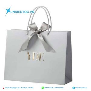 Túi giấy sử dụng chất liệu tốt, gắn nơ và in tên thương hiệu, đơn giản nhưng sang trọng. Túi giấy sử dụng chất liệu tốt